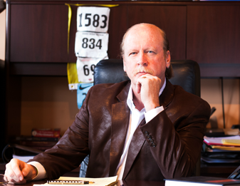 Kevin Regan sitting at his office desk